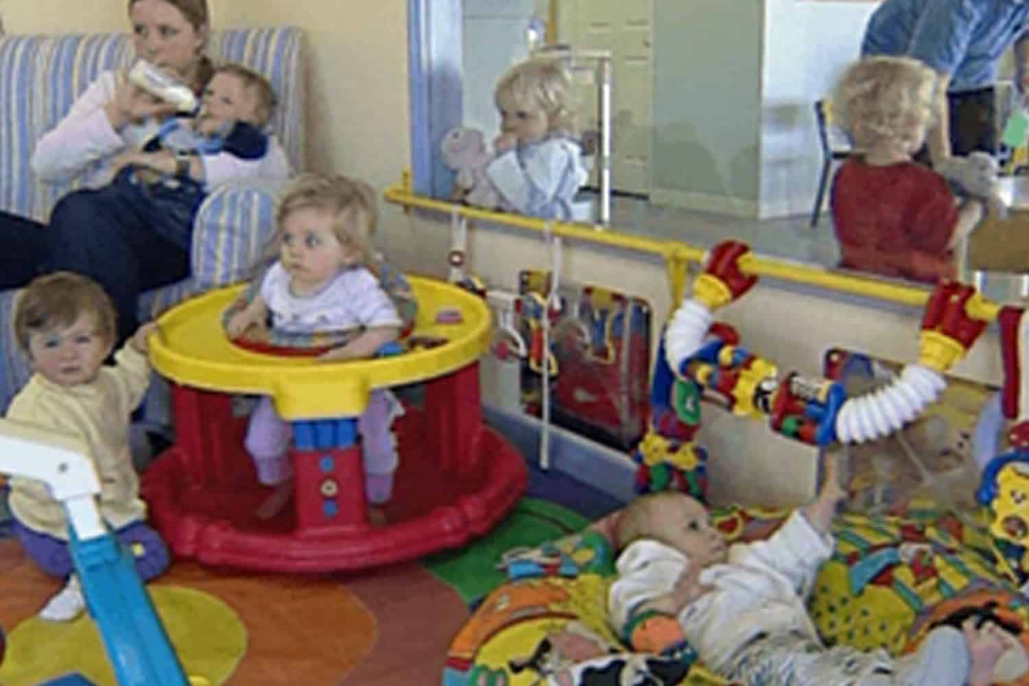 Teacher caring for babies in early childhood centre