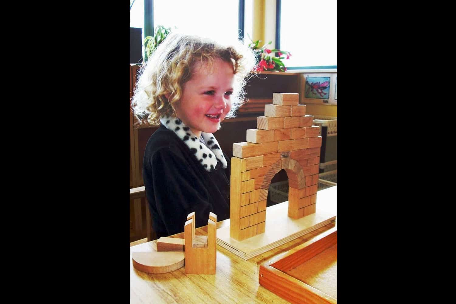 Montessori equipment child does Roman Arch