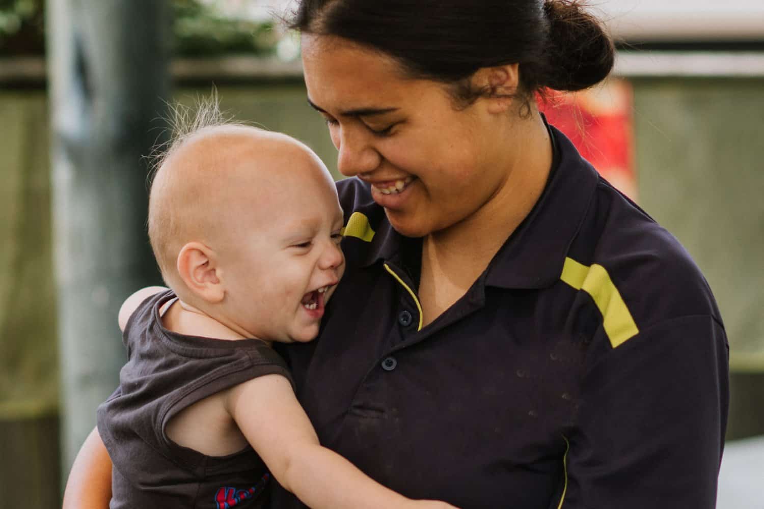 Fijian teacher caring for children