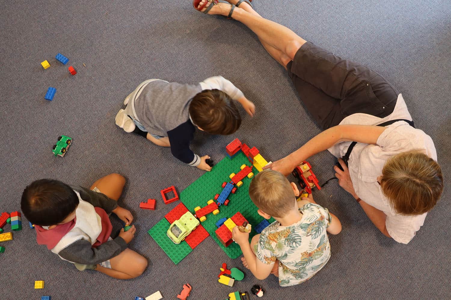 teacher with children on mat early learning curriculum