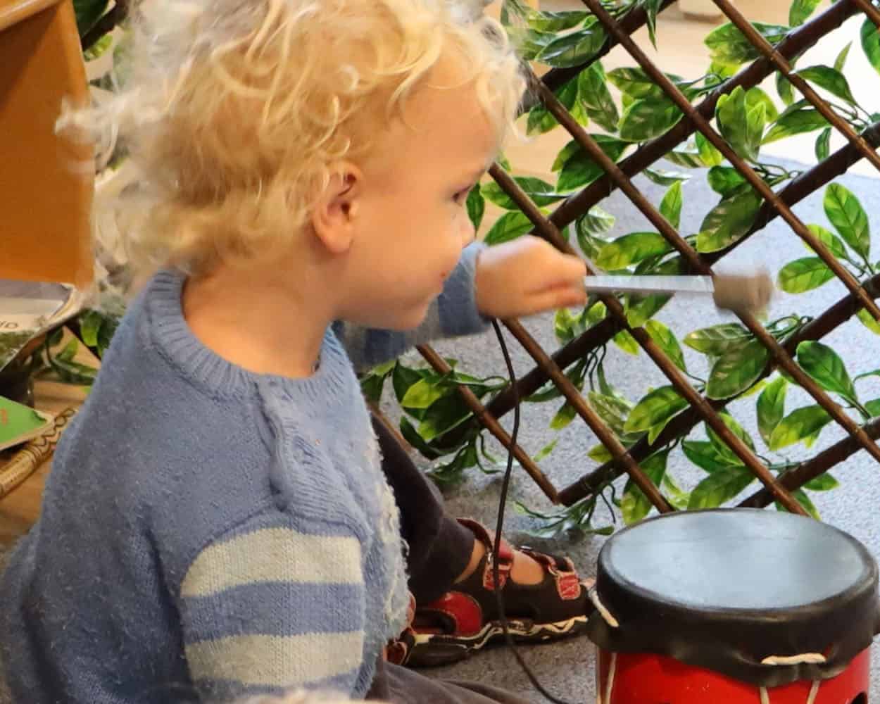 Daycare toddler is banging a drum - listen to me!