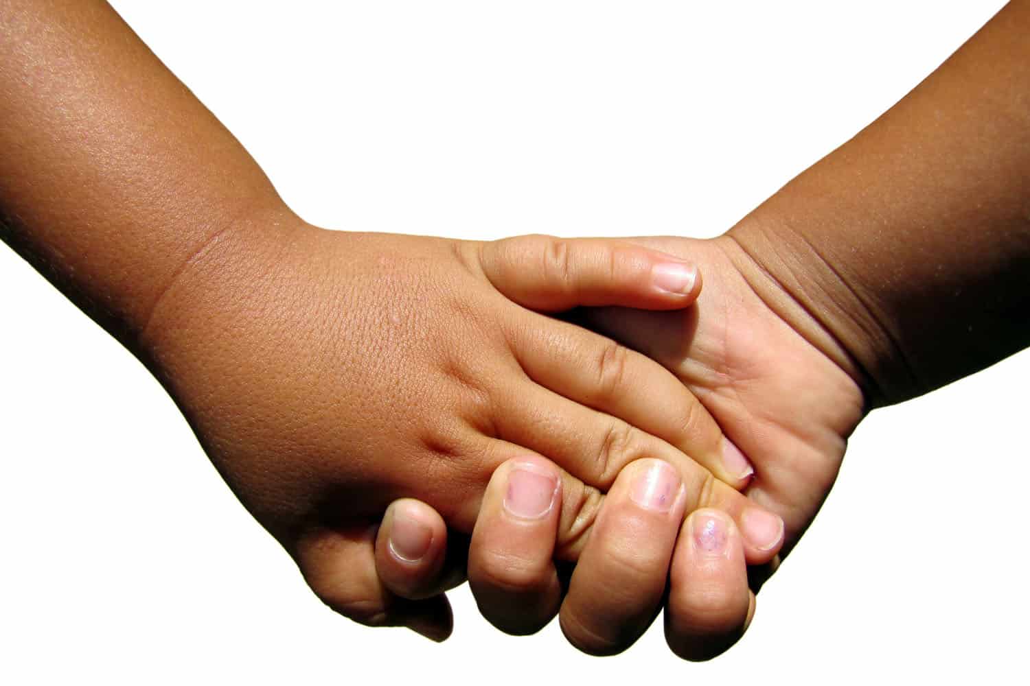 Holding hands showing friendship of two young children in childcare.